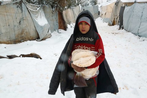 Displaced Syrian families and children living in refugee camps during harsh winter conditions,