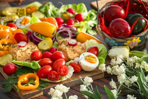Vegetarian snack for Easter, hummus, fresh vegetables, eggs and pastries