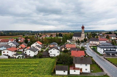 Drone shot, view of village with church, Burgkirchen, Innviertel, Upper Austria, Austria