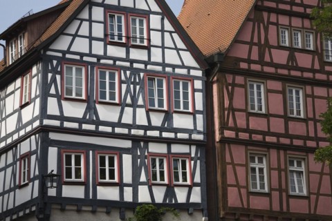 Half timbered white with black and burgundy with brown residential buildings with traditional