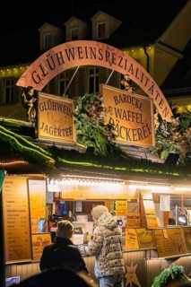 A mulled wine stall at a Christmas market at night, animated and decorated, Christmas market