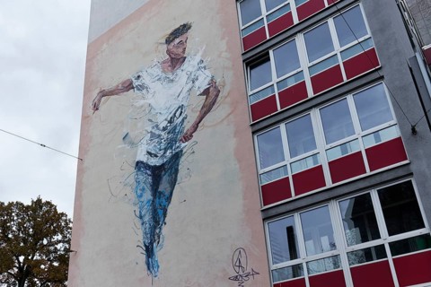 Mural of a young man of colour for UEFA EURO 2024, by street artist Alexis Bust Stephens,