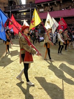 Il Palio di Siena, historical horse race, entry of the contrade in costumes with flags into the