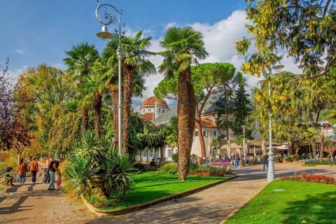 Palm tree promenade at the spa hotel, Merano, Burggrafenamt, Adige Valley, South Tyrol, Italy