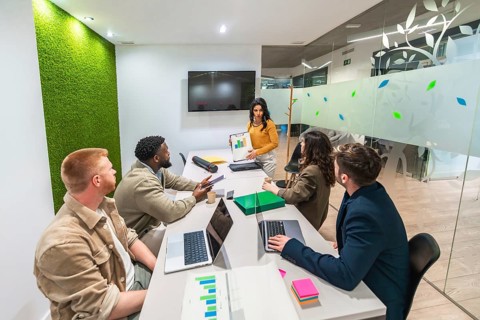 Diverse colleagues collaborating, analyzing marketing data, and developing strategies for