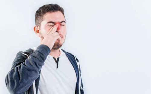 Person with sinusitis and nasal inflammation. Man with nasal congestion isolated