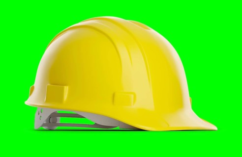 Yellow construction hard hat isolated on a green screen