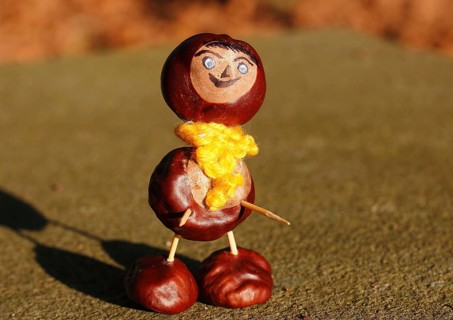 Chestnut figure with yellow scarf on wall, North Rhine-Westphalia, Germany