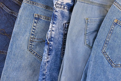 Top view of different colored blue jeans pants