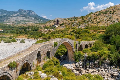 Summer view of the Old Mes bridge near Shkoder. Albania, Europe. Ottoman stone arch bridge Ura e