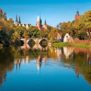 Merseburg Cathedral and Merseburg Castle reflected in the river Saale in autumn, Merseburg,