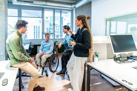 Businesspeople collaborating in a modern office, demonstrating inclusion and teamwork with a
