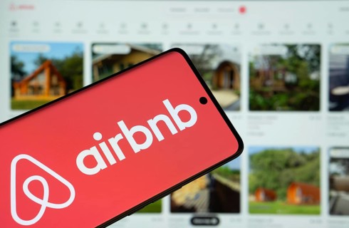 Airbnb logo is seen on a smartphone