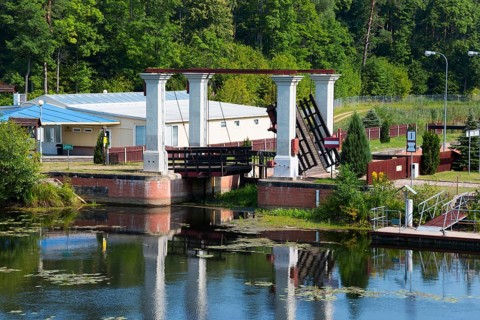 Lock bridge with neighbouring building in the countryside on a summer's day, Sluza Kurzyniec,