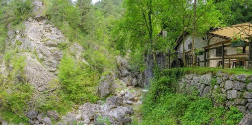 Mill wheel and waterfall at the old mill, Tramonti di Sopra, Province of Pordenone, Italy