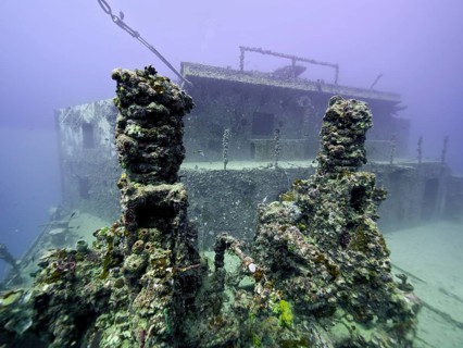 Close-up of a coral-covered shipwreck on the seabed, dive site wreck of the USS Spiegel Grove, John
