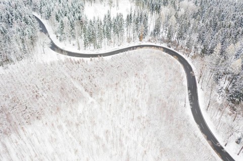 Aerial view of a winding country road and forest in the snow, between Eppendorf and Leubsdorf,