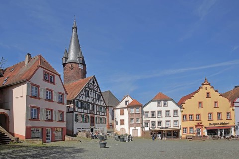 Historic houses with tail gables, half-timbered houses and old tower of the Protestant church,