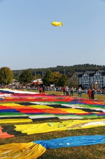 Hot-air balloons, many balloon envelopes lying on the ground, preparation for mass launch, hot-air