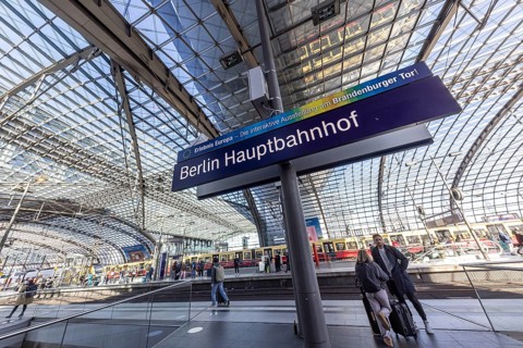 Berlin Central Station with station sign, pillarless glass roof construction above the platforms.
