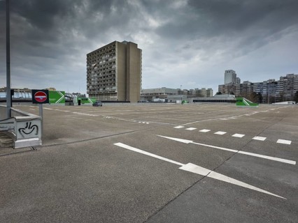 Symbolic image economic crisis, dark clouds in the sky, empty parking deck at
