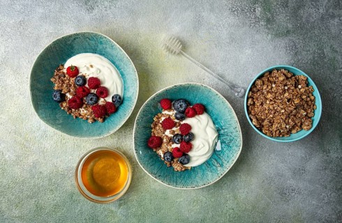 Breakfast, two bowls, yogurt, muesli with berries, and honey, homemade, no people
