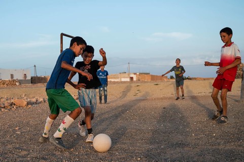 Taouloukoult, MOROCCO - OCTOBER 6, 2024: young boys spend the afternoon playing amateur football on