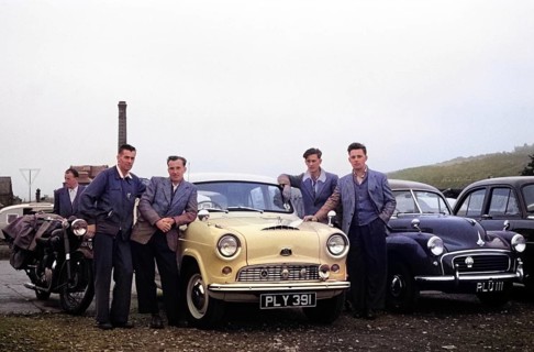 Four men standing by Austin Cambridge A40 car starting overland drive adventure across Europe,