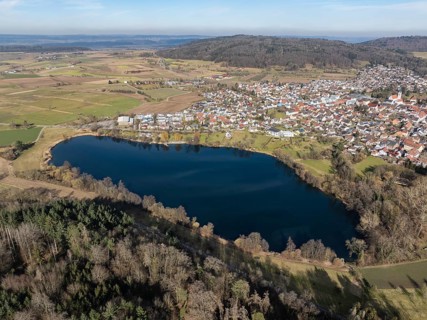 Aerial view of the municipality of Steißlingen with the natural bathing lake Steißlinger See,
