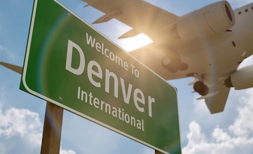 Welcome to denver international airport green road sign with airplane above
