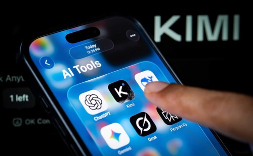 In this photo illustration, a person uses the Kimi AI chatbot on a smartphone while the KIMI logo