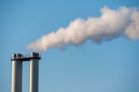 Smoke rises from industrial chimneys into the clear sky, Baden-Württemberg, Germany