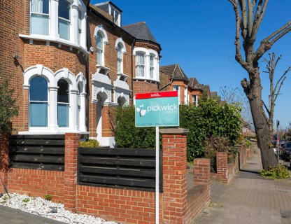 Sold estate agent property sign outside houses for sale, Barry Road, East Dulwich, London SE22,