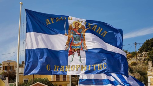 Flag with the Archangel Michael, Greek flag with an angel on a blue and white background on a sunny