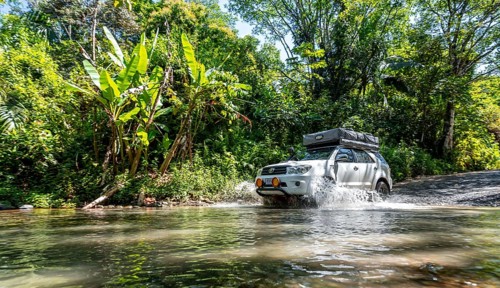 4x4 car drives through a river, water crossing with the off-road car, Costa Rica
