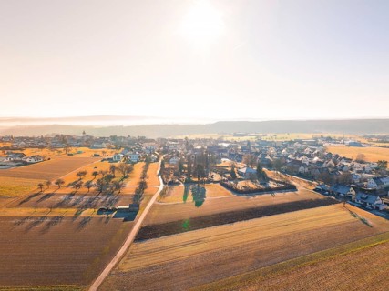 Small village surrounded by fields under bright sun and autumnal atmosphere, Neubulach, Black