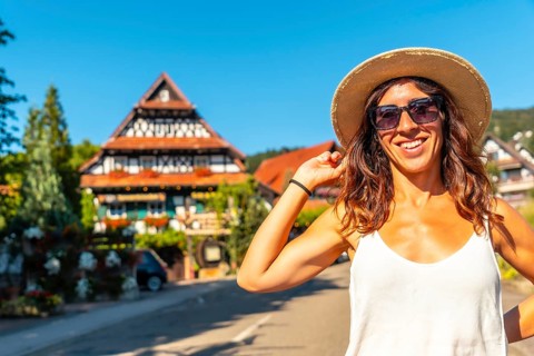 Portrait of a female tourist in summer in the medieval mountain village of Sasbachwalden, Black