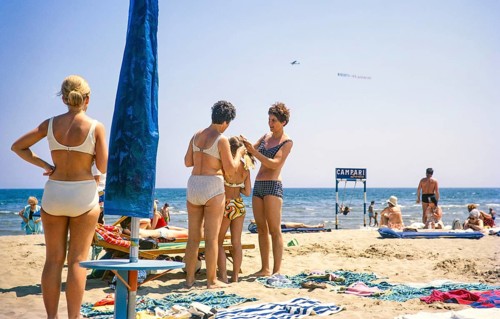 People sunbathing on a sandy beach by the sea in Rimini, Emilia Romagna region, Italy 1969