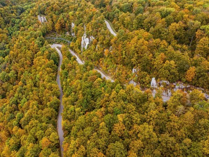 Swabian Alb in autumn, Albtrauf with colourful mixed forest and winding country road. Bad Urach,