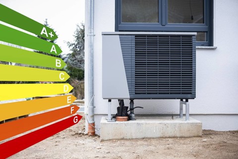 Heat pump on a new single-family house, graphics with energy efficiency classes according to the