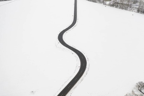 Aerial view of a winding country road in the snow, between Eppendorf and Leubsdorf, Central Saxony,