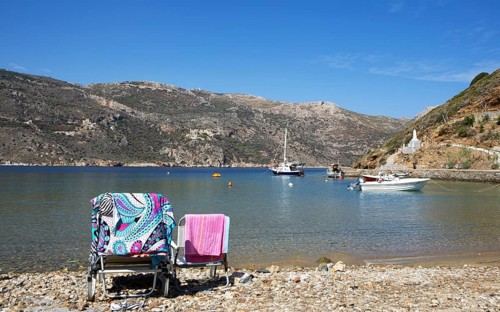 Deckchairs on the pebble beach in Porto Kagio, Mani on the Laconian Gulf, Laconia, Peloponnese,