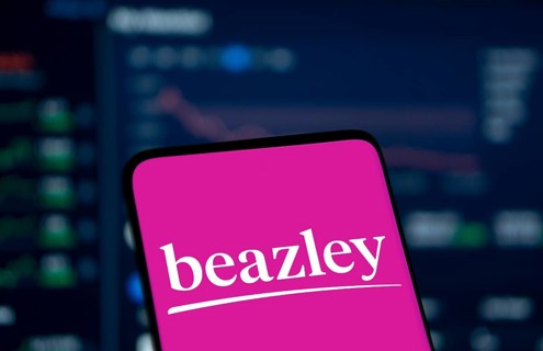 Beazley logo is displayed on smartphone. Beazley plc is the British parent company of specialist