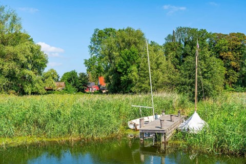 Sailing boats and reeds in Krummin natural harbour, Krumminer Wiek on the Peene River, Usedom