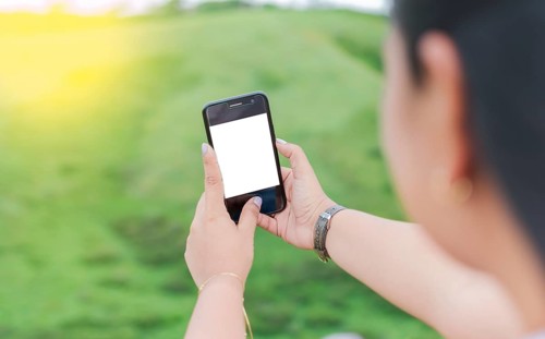 Blank cell phone screen of a girl taking a selfie. Mockup of a person Hand Holding Mobile Phone