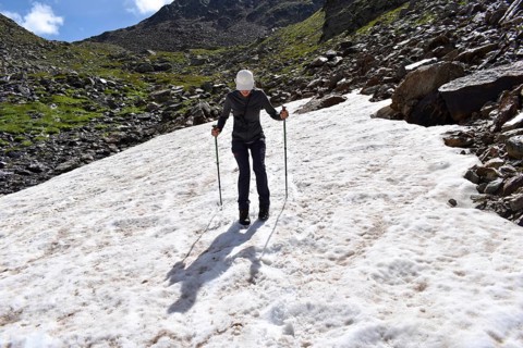 Mountaineer slips over a not very dangerous snowfield on the descent from the Weiße Spitze,