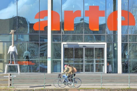 Entrance to the modern building of the ARD and ZDF broadcasting station Arte with sculpture Giraffe