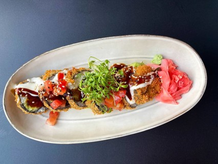 Sushi, vegan, Big Crunchy Role with tomatoes, pickled radish, avocado, wasabi mayonnaise, teriyaki