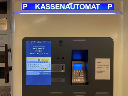 Automatic pay station in multi-storey car park, parking ticket machine with number plate