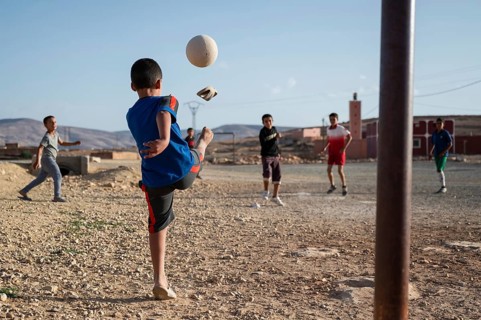 Taouloukoult, MOROCCO - OCTOBER 6, 2024: A boy's flip-flop falls off his foot while kicking the